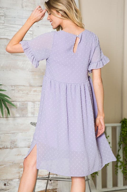 This flowy little dress is made from a textured chiffon that drapes beautifully, showing off your curves and making you feel extra cute. The ruffle sleeve detail adds femininity, while the button back provides coverage. An elastic shirred waist and side slits add an element of comfort and style. Easily transition from work to play with this gorgeous dress! Avah Couture