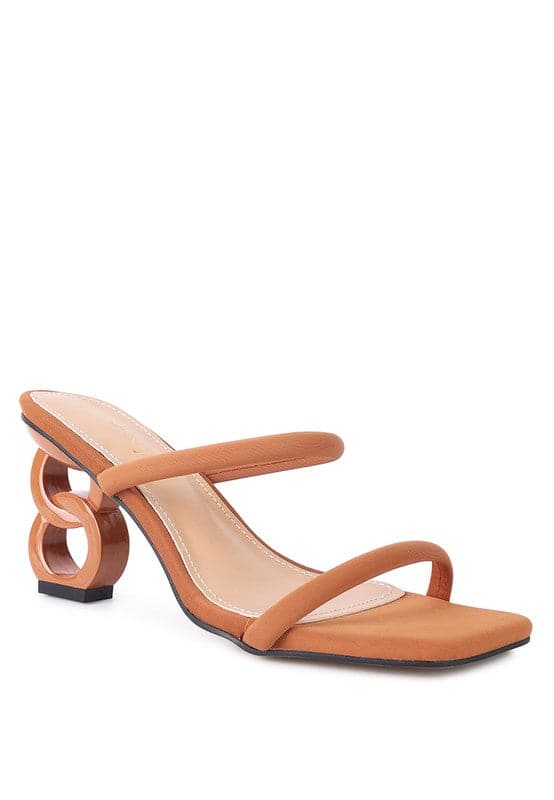 The Eternity is a double-strap sandal with a unique resin chain heel that adds a new dimension to this classic style. This mid-heel sandal is feminine, fun, and a perfect addition to your shoe collection.  Avah Couture