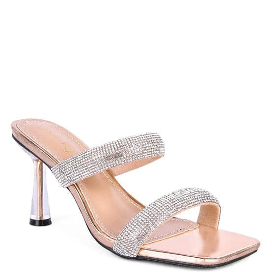 These mid heel slides are a beauty to behold. The pointed metallic heel is enclosed in clear detail, while the square toe and double strap give this shoe an air of sophistication that is accentuated by the diamanté detail. Prepare to turn heads as you walk in these beauties! Nude color. Avah Couture
