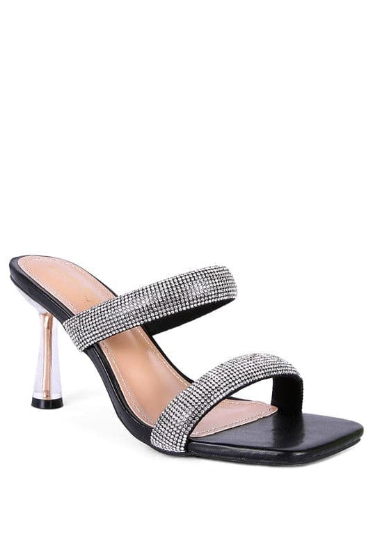 These mid heel slides are a beauty to behold. The pointed metallic heel is enclosed in clear detail, while the square toe and double strap give this shoe an air of sophistication that is accentuated by the diamanté detail. Prepare to turn heads as you walk in these beauties! Black color. Avah Couture