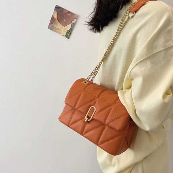 This quilted vegan leather bag is a conversation starter. It’s definitely a bag that you carry around and wear everywhere you want to stand out. This bag has a shoulder length chain strap that can be doubled up to carry shorter, and has dual inside compartment with inner zipper pocket. Gold turn lock closure completes the look. 