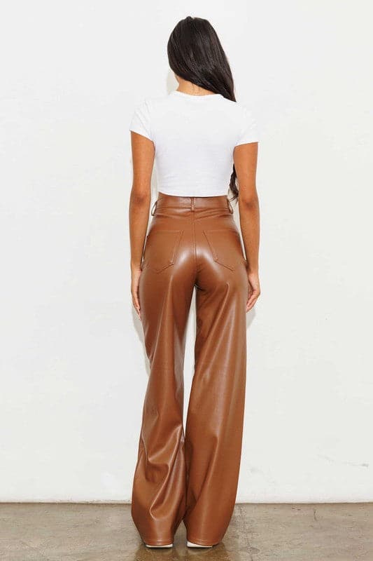 Show off what you’ve got in our chic, wide leg pants. Made out of supple vegan leather, they’re flattering and daring the perfect style for the modern woman who doesn’t play by the rules. Cognac color. Avah Couture