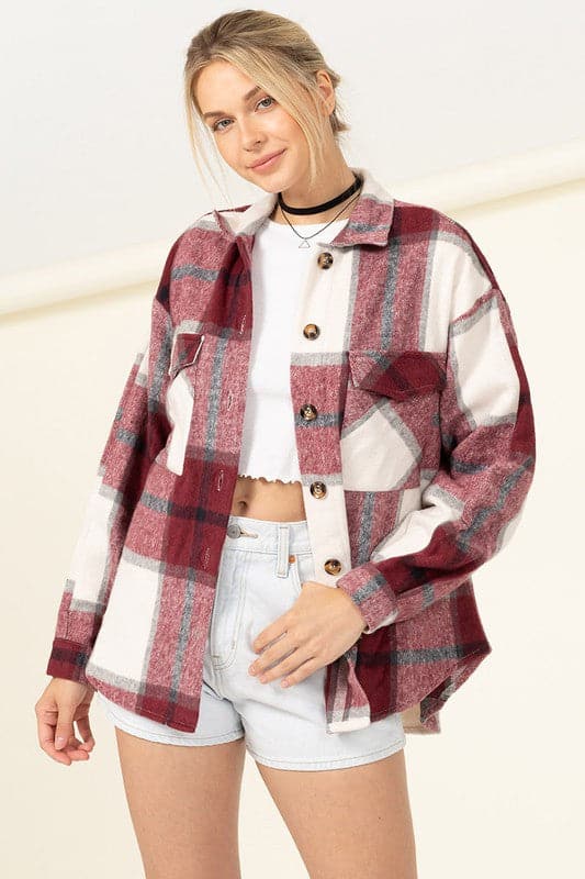 Mix a bit of classic with a pop of fashion with this shacket! It’s covered in a plaid print and features a collared neckline, two front flap pockets, functional button placket down the center and an oversized bodice. This shacket is the perfect layer for all of your fall activities.  Avah Couture