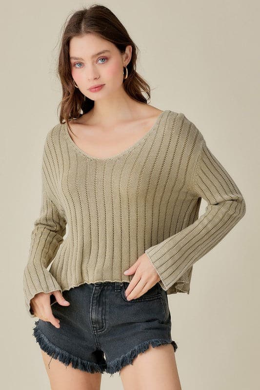 This knitted pullover is the perfect piece for you to wear in any season. With a loose and relaxed fit, it is designed to be paired with anything from jeans to shorts to skirts to dresses. It features a cropped style, which allows you to dress it up or down. It also has a v neck front which adds an elegant touch for those more formal affairs. In short, this sweater is versatile and can be worn by anyone at anytime in any environment. Avah Couture