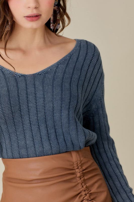 This knitted pullover is the perfect piece for you to wear in any season. With a loose and relaxed fit, it is designed to be paired with anything from jeans to shorts to skirts to dresses. It features a cropped style, which allows you to dress it up or down. It also has a v neck front which adds an elegant touch for those more formal affairs. In short, this sweater is versatile and can be worn by anyone at anytime in any environment. Avah Couture