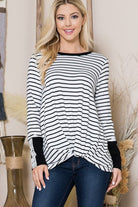 The Stripe Light Sweater is a cozy fall staple for every girl’s closet. With a relaxed fit and flattering twist front, this top can be styled with comfortable jeans or your favorite leggings. The lace trim sleeves add a romantic touch to the design, making it perfect for date night or an afternoon coffee date with friends.