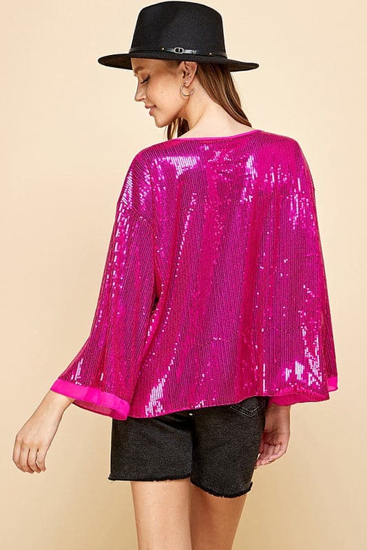 Celebrate any special occasion in this festive top! Featuring a solid sequin design, round neck and bell sleeves, as well as full lining, it’s the perfect addition to your party wardrobe. Perfect for celebrating the holidays! Avah Couture