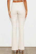 Add a touch of luxury to your wardrobe with these vegan leather pants. Chic, yet comfortable and stylish, they’re versatile enough to be worn anywhere. High waisted with a button fly closure, the front slit detail adds interest to the design while the stretch fabric helps these pants move with you throughout the day.   Avah Couture