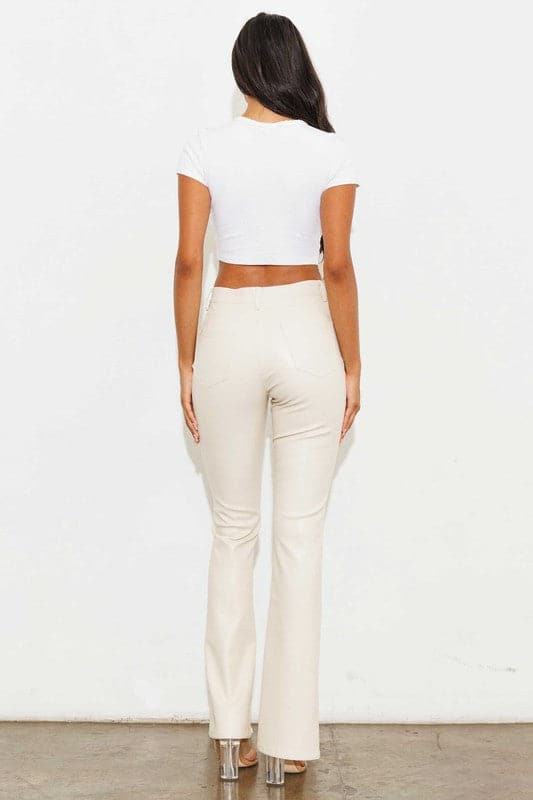 Add a touch of luxury to your wardrobe with these vegan leather pants. Chic, yet comfortable and stylish, they’re versatile enough to be worn anywhere. High waisted with a button fly closure, the front slit detail adds interest to the design while the stretch fabric helps these pants move with you throughout the day.   Avah Couture