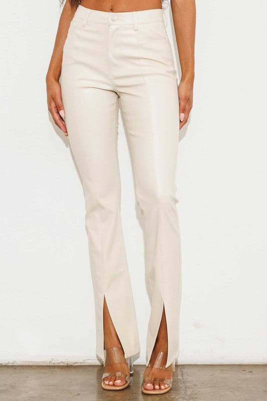 Add a touch of luxury to your wardrobe with these vegan leather pants. Chic, yet comfortable and stylish, they’re versatile enough to be worn anywhere. High waisted with a button fly closure, the front slit detail adds interest to the design while the stretch fabric helps these pants move with you throughout the day.   Avah Couture