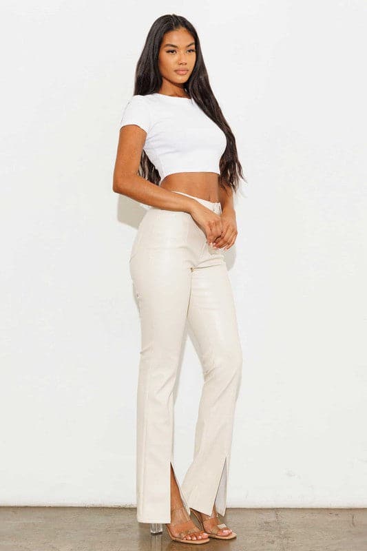 Add a touch of luxury to your wardrobe with these vegan leather pants. Chic, yet comfortable and stylish, they’re versatile enough to be worn anywhere. High waisted with a button fly closure, the front slit detail adds interest to the design while the stretch fabric helps these pants move with you throughout the day.   Avah Couture