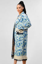 Avah Couture-Make an impact wherever you go in this feminine and trendy coat. This versatile piece is made with a beautiful blue and white floral print and will add style to any outfit. With its longline silhouette, this trench coat features a matching belt tie, button front closure, and a unique tassel fringe that decorates the hem, sleeves, and pockets.  Floral print Tassel fringe detail Collared neckline Notched lapels Belt tie Pockets Oversized fit