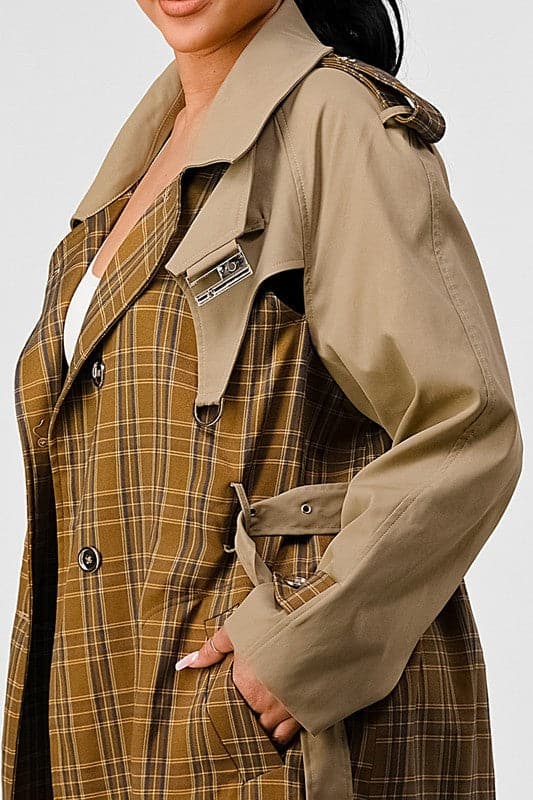 With its plaid and khaki color contrast, this luxurious trench coat is sure to be your new go to for fall and winter. The high quality of the fabric gives it great durability as well as style, making this a favorite among trend setters. With a hook and eye collar closure, back cutout detail, long sleeve, and collared style, this trench coat will look good with anything you wear it with. You can’t go wrong in this unique coat! Avah Couture