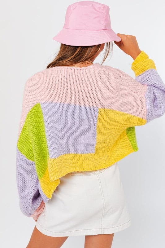 This colorful cardigan sweater is perfect for any season. The cheery color block pattern makes this an easy wardrobe staple to add to your daily look. Designed with a long sleeve and cropped length, this sweater works great over a tank top, long sleeved tee, or short dress.  Avah Couture