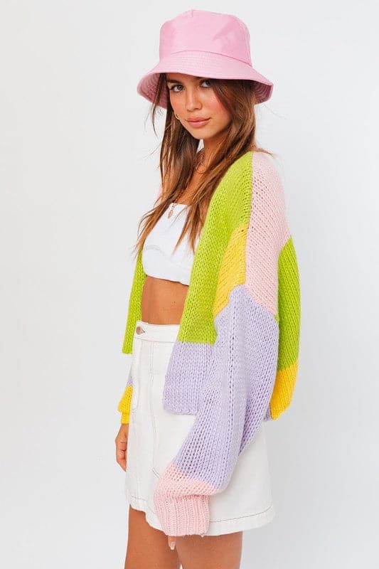 This colorful cardigan sweater is perfect for any season. The cheery color block pattern makes this an easy wardrobe staple to add to your daily look. Designed with a long sleeve and cropped length, this sweater works great over a tank top, long sleeved tee, or short dress.  Avah Couture