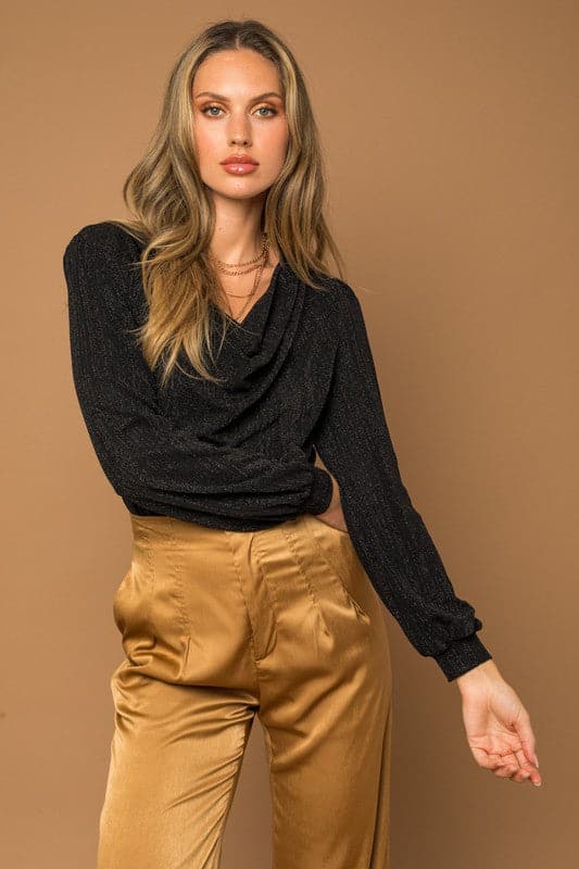 A classic cowl neck, bodysuit is an essential piece of clothing to have in your closet. It’s perfect for the office or a night out, and can be styled both day and night. It comes in long sleeve, so it’s versatile enough to wear year round. Whether you’re headed to work or planning a fun night out, this special occasion bodysuit has got you covered. Avah Couture