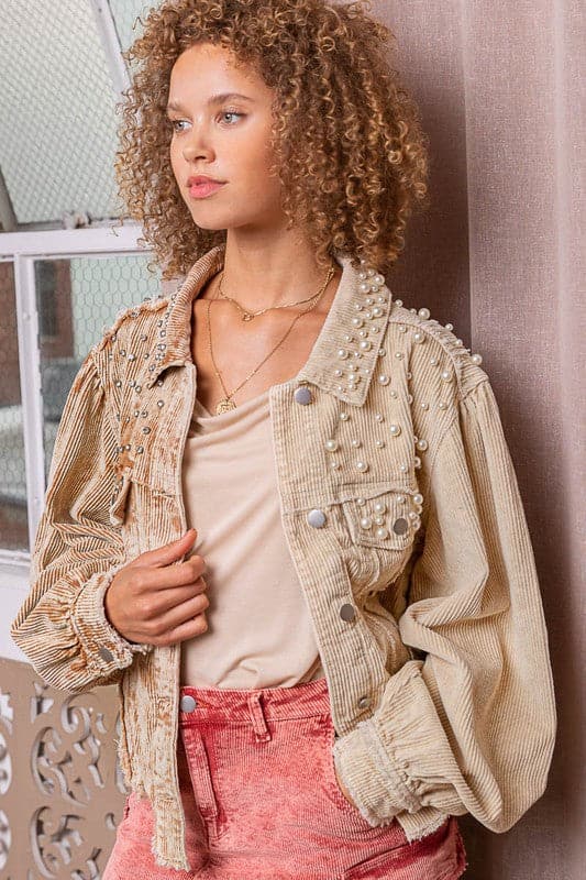 This button down high low corduroy jacket is embroidered with pearls, giving it a unique feel. The color blocking and oversized fit makes it fun and stylish, while the long balloon sleeve with button on the opening gives it an edgy touch. You can wear this piece overmans or a skirt for a casual look, or dress it up for special occasions. Avah Couture