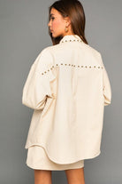 This casual, yet fashionable shirt jacket is a fall favorite! It features chest pockets with stud detail and button closure, as well as a taupe color. This versatile piece can be worn over your everyday closet staples to make them look upscale and trendy. Wear it with jeans and boots for a casual weekend look, or use to dress up your favorite dress. Avah Couture