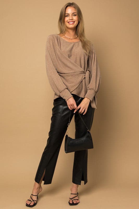 Wrap and tie it up! This fashionable top features a dolman sleeve, wrap front with tie, and boat neckline. Pair it with your favorite vegan leather pants or skirt for an effortlessly chic look.  Avah Couture