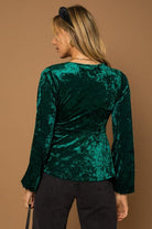 This wrap front velvet top is perfect for your next holiday party. This long sleeve top features a wrap front with waist tie that is sure to add some style to your look! Avah Couture