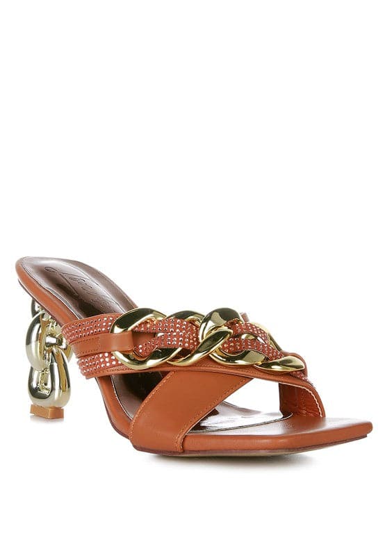 Give your look a unique touch of creativity with these stylish metallic chain-heeled sandals. The golden chain strap and head-turning diamante detail will give any outfit the right amount of edge and glamour. Chic, unique, and full of style. Avah Couture