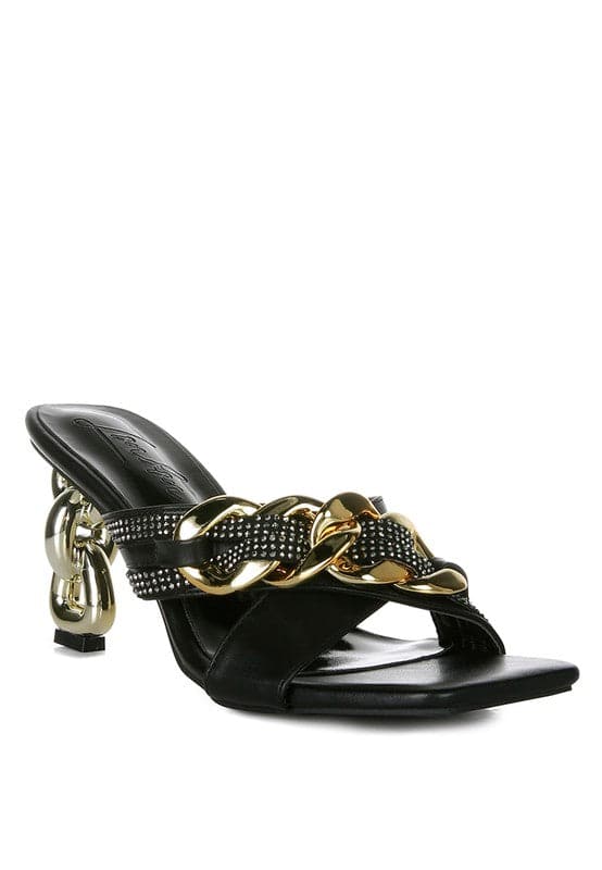 Give your look a unique touch of creativity with these stylish metallic chain-heeled sandals. The golden chain strap and head-turning diamante detail will give any outfit the right amount of edge and glamour. Chic, unique, and full of style. Avah Couture