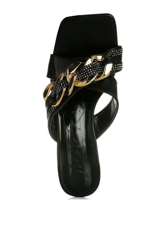 Give your look a unique touch of creativity with these stylish metallic chain-heeled sandals. The golden chain strap and head-turning diamante detail will give any outfit the right amount of edge and glamour. Chic, unique, and full of style. Avah Couture