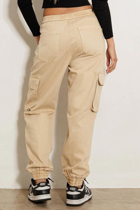 A pair of high-rise cargo jeans featuring wide cargo pockets, elastic leg openings, classic 5-pocket construction and zip-fly closure, these are a must have wardrobe essential. Tuck in your favorite tee, add a bomber jacket and some sneakers and you’re ready to take on anything from running errands to traveling in these versatile pants.  Avah Couture