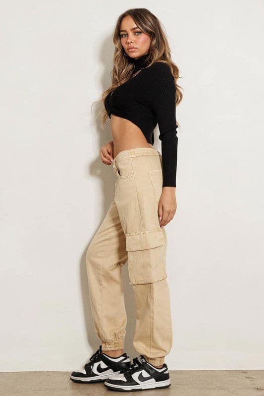 A pair of high-rise cargo jeans featuring wide cargo pockets, elastic leg openings, classic 5-pocket construction and zip-fly closure, these are a must have wardrobe essential. Tuck in your favorite tee, add a bomber jacket and some sneakers and you’re ready to take on anything from running errands to traveling in these versatile pants.  Avah Couture