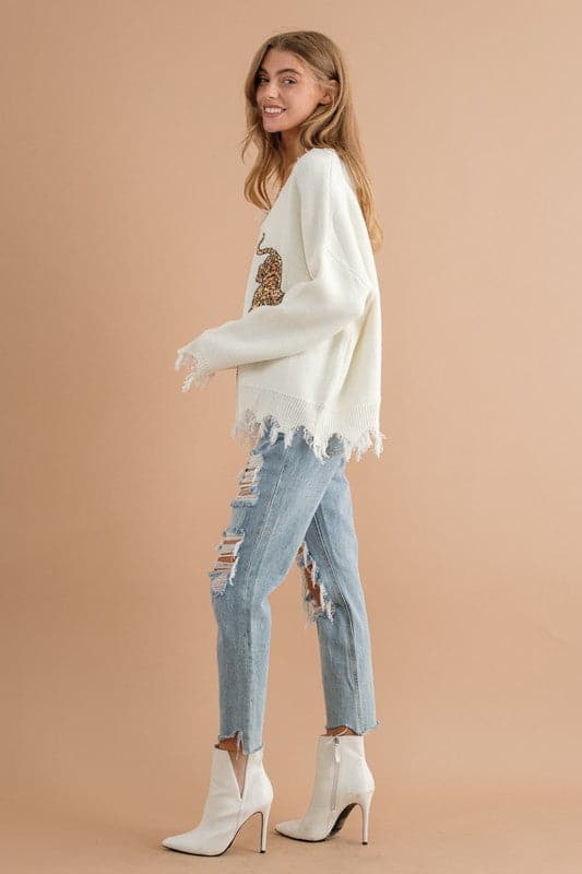 You’ll love this fun, edgy sweater. It’s the perfect way to express your wild side! This v-neck, pullover sweater features sequin tigers and frayed edges, making it the perfect top for weekend outings and casual get-togethers - Avah Couture