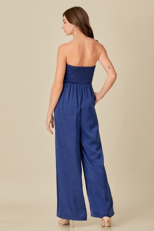 A sophisticated yet effortless style, this top detail jumpsuit is designed in a smocked back tup top style with wide legs. An overlap detail front gives it a chic, modern look that goes with everything in your wardrobe. Avah Couture