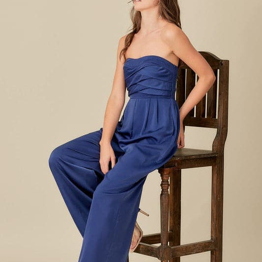 A sophisticated yet effortless style, this top detail jumpsuit is designed in a smocked back tup top style with wide legs. An overlap detail front gives it a chic, modern look that goes with everything in your wardrobe. Avah Couture