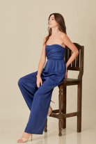 A sophisticated yet effortless style, this top detail jumpsuit is designed in a smocked back tup top style with wide legs. An overlap detail front gives it a chic, modern look that goes with everything in your wardrobe. Avah Couture