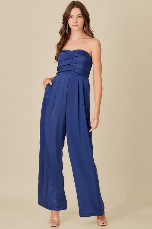 A sophisticated yet effortless style, this top detail jumpsuit is designed in a smocked back tup top style with wide legs. An overlap detail front gives it a chic, modern look that goes with everything in your wardrobe. Avah Couture