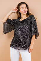 Holiday sparkle! This blouse is perfect for any occasion. All you need is a new pair of strappy sandals and your favorite trousers or jeans and you’re ready to go. Features glittered print, tulip sleeves and full lining. Avah Couture