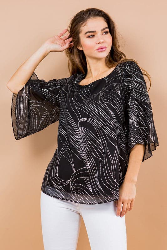 Holiday sparkle! This blouse is perfect for any occasion. All you need is a new pair of strappy sandals and your favorite trousers or jeans and you’re ready to go. Features glittered print, tulip sleeves and full lining. Avah Couture
