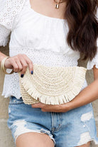 This perfectly sized straw clutch has an airy, casual feel, making it a great everyday option. The frayed edge detail adds a touch of whimsy to this functional piece. The interior is lined and includes a sidewall pocket and a zip pocket.  Fold over Clasp closure Straw exterior Cotton linen lining Frayed detail Interior sidewall Zip pocket