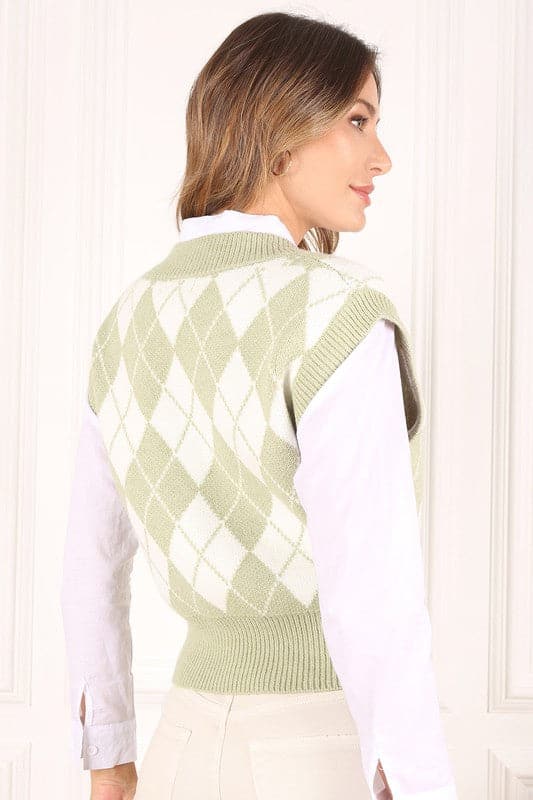 A knitted vest is a must have for fall and winter, and this version features an argyle pattern and V neckline to add some interest. It's sleeveless so you can wear it alone or layered over a button down shirt or tank. Green color. Avah Couture