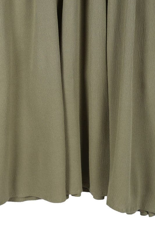 This beautiful midi dresses has four tiers of elastic bands at the bodice which creates a lovely ruched effect. This design gives it an elegant and feminine appearance. The All Dressed Up Ruched Midi Dress has a boat neckline, long sleeves with button at each cuff and below the knee length for easy transition into fall. Wear it with heels and a clutch bag for a chic look. This dress is lined.  