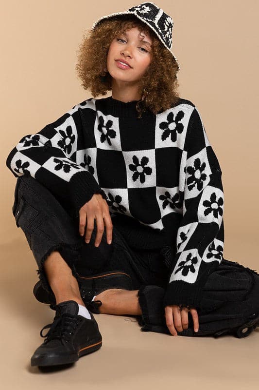 Our most popular style, this oversized sweater top is crafted with a round neckline and long sleeves for easy layering. A unique flower and checkerboard pattern creates an eye catching look. Ribbed edges add graphic detail and make it easy to pair with your favorite jeans or leggings. The irresistible oversized fit will never go out of style! Avah Couture