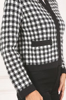A classic piece that has timeless style, the Black And White Check Jacket is a must have this season. The heavy weight knit fabric features a black and white check pattern that gives it its name. A perfect balance of comfort and style, this jacket features 4 front snap buttons and 2 functional pockets. Wear it with your favorite outfit to work or play a classic piece to get you through any occasion! Avah Couture