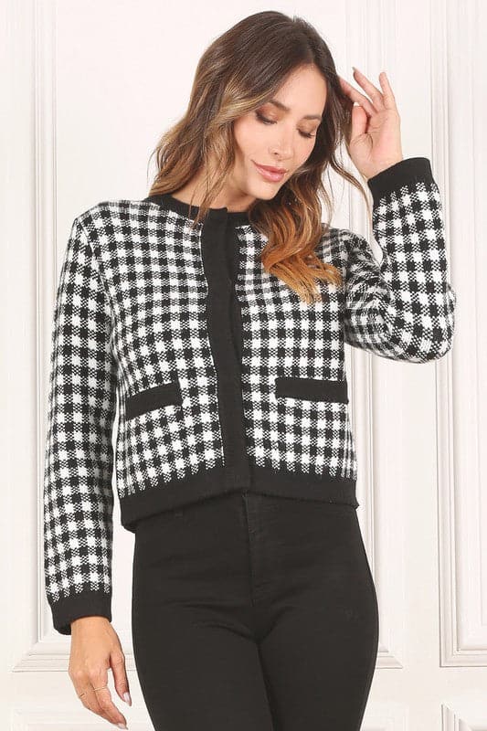 A classic piece that has timeless style, the Black And White Check Jacket is a must have this season. The heavy weight knit fabric features a black and white check pattern that gives it its name. A perfect balance of comfort and style, this jacket features 4 front snap buttons and 2 functional pockets. Wear it with your favorite outfit to work or play a classic piece to get you through any occasion! Avah Couture