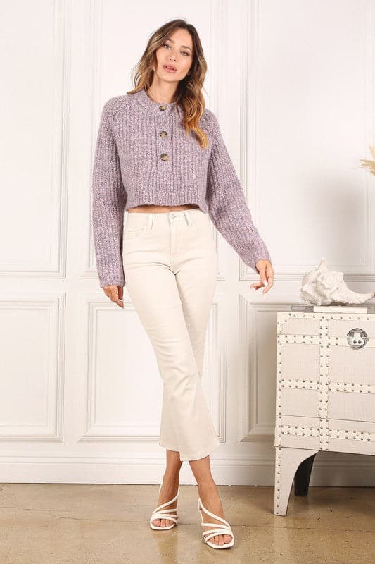 Wear the Melange Crop Sweater to keep warm and look chic. Its half placket features 3 bold plastic buttons, creating a cozy and warm feel. Side slit, round neck and raglan sleeves are all perfect for layering under coats and jackets. Wear it with your favorite jeans or leggings for a casual yet stylish outfit. Avah Couture