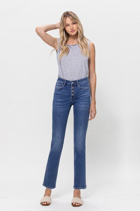 A classic button up jean with a comfortable stretch denim fabric. This mid rise straight leg jean features a versatile cut and elongated hem to create a sleek silhouette with plenty of coverage. A flattering wash that makes it great for pairing with heels or sneakers, this is a must have piece for your wardrobe. Avah Couture