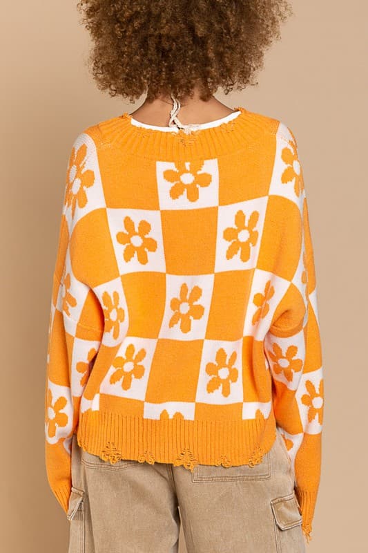 Our most popular style, this oversized sweater top is crafted with a round neckline and long sleeves for easy layering. A unique flower and checkerboard pattern creates an eye catching look. Ribbed edges add graphic detail and make it easy to pair with your favorite jeans or leggings. The irresistible oversized fit will never go out of style! Avah Couture