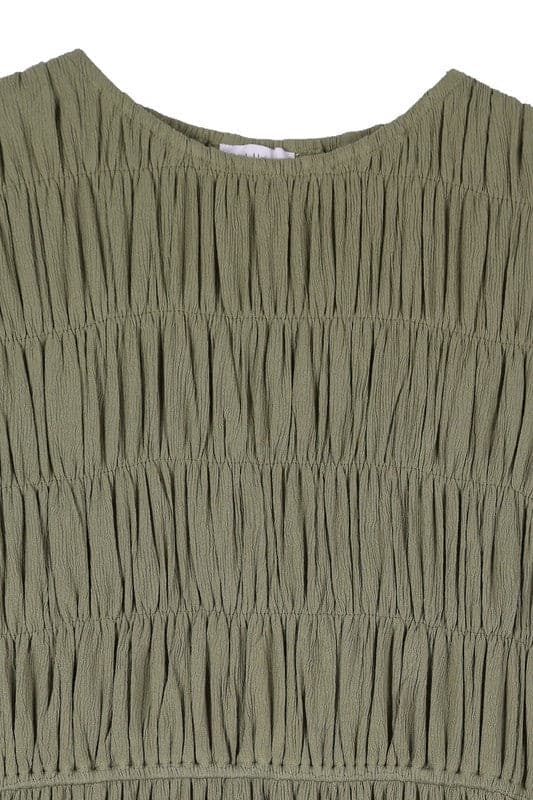 This beautiful midi dresses has four tiers of elastic bands at the bodice which creates a lovely ruched effect. This design gives it an elegant and feminine appearance. The All Dressed Up Ruched Midi Dress has a boat neckline, long sleeves with button at each cuff and below the knee length for easy transition into fall. Wear it with heels and a clutch bag for a chic look. This dress is lined.  