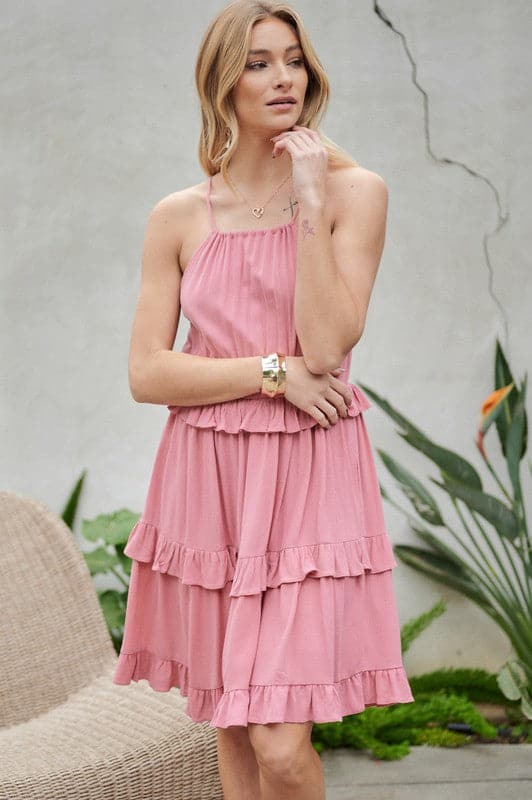Let the sun shine in with this halter top sundress. Featuring ruffles and tiers, it’s the perfect mix of comfortable and cute. With pockets to keep you organized, this is the best mini dress you need to add to your closet. Avah Couture