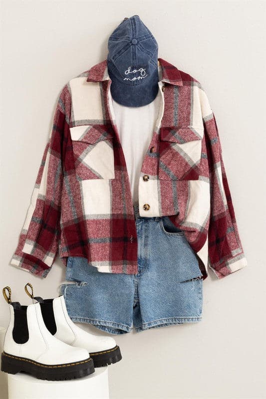 Mix a bit of classic with a pop of fashion with this shacket! It’s covered in a plaid print and features a collared neckline, two front flap pockets, functional button placket down the center and an oversized bodice. This shacket is the perfect layer for all of your fall activities.  Avah Couture