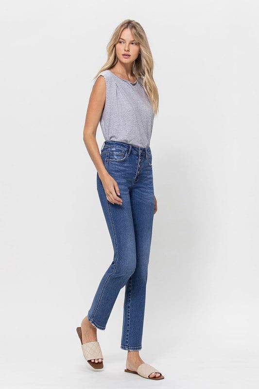 A classic button up jean with a comfortable stretch denim fabric. This mid rise straight leg jean features a versatile cut and elongated hem to create a sleek silhouette with plenty of coverage. A flattering wash that makes it great for pairing with heels or sneakers, this is a must have piece for your wardrobe. Avah Couture