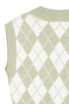 A knitted vest is a must have for fall and winter, and this version features an argyle pattern and V neckline to add some interest. It's sleeveless so you can wear it alone or layered over a button down shirt or tank. Green color. Avah Couture
